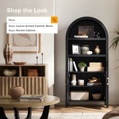 a living room with a black bookcase next to a coffee table and potted plant