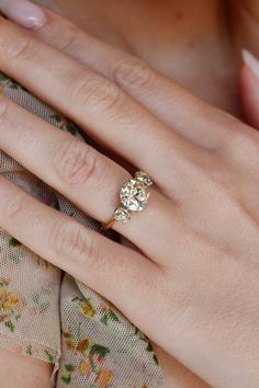 a woman's hand with a diamond ring on it