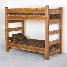 a wooden bunk bed sitting on top of a carpeted floor next to a wall