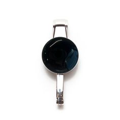 a black glass object is hanging from a hook