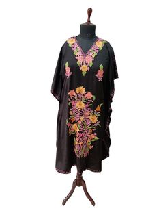 Crush cotton embroidered Kaftan with great fall and soft in touch. Actual length 43 Inch Free size color black with multi color embroidery Made in Kashmir -India Black Long Kaftan With Intricate Embroidery, Traditional Black Kaftan With Floral Embroidery, Black Kaftan With Intricate Embroidery For Festivals, Black Resham Embroidered Fabric, Black Resham Embroidery Fabric, Spring Cotton Kaftan With Multicolor Embroidery, Folk Style Cotton Kaftan With Floral Embroidery, Black Bohemian Embroidered Fabric For Festivals, Black Bohemian Embroidered Fabric