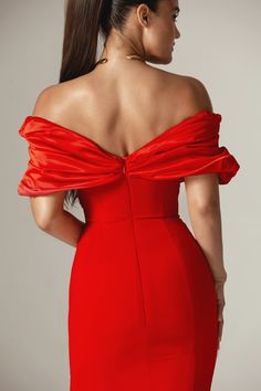 a woman in a red dress with her back to the camera