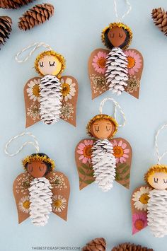 paper angel ornaments with pine cones and twine