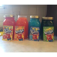 four different flavors of kool - aid are lined up on a kitchen counter top