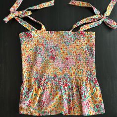 J Crew Multi Color Floral Print Smocked Tank Top. Adjustable Tie Shoulder Straps. Great Condition, Never Worn Multicolor Sleeveless Smocked Top With Floral Print, Yellow Fitted Smocked Top, Fitted Yellow Smocked Top, Summer Multicolor Smocked Top With Smocked Cuffs, Multicolor Summer Top With Smocked Cuffs, Summer Multicolor Top With Smocked Cuffs, Multicolor Sleeveless Smocked Top For Vacation, Summer Multicolor Sleeveless Smocked Top, Multicolor Sleeveless Smocked Summer Top