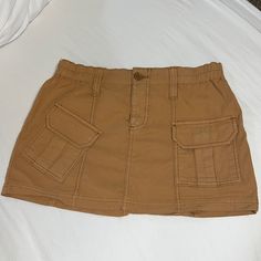 Brand New Mini Cargo Skirt From Urban Outfitters! It Is Meant To Be Very Short And Is A Low/Mid Rise Style Casual Mini Skort With Pockets, Casual Mini Bottoms With Pockets, Casual Mini Skort With Lined Skirt, Casual Brown Short Skort, Brown Cotton Mini Skirt With Pockets, Casual Brown Lined Skirt, Urban Outfitters High Waist Casual Skirt, Casual High Waist Skirt From Urban Outfitters, Urban Outfitters Casual High Waist Skirt