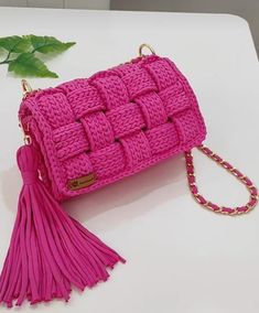 a pink purse sitting on top of a white table