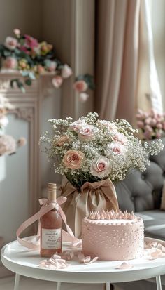 a table with a cake, bottle and flowers on it