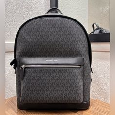 Michael Kors Hudson Logo Backpack Brand New Genuine Leather Men’s.. But In My Opinion Could Be Men’s Or Women’s Has A Padded Interior Laptop Sleeve Luxury Gray Bag With Zipper Closure, Michael Kors Business Bags With Branded Hardware, Designer Michael Kors Business Bags, Designer Gray Travel Bag, Michael Kors Business Bag, Designer Gray Bag With Branded Hardware, Black Coated Canvas Backpack With Removable Pouch, Michael Kors Standard Backpack For Travel, Michael Kors Designer Backpack For Daily Use