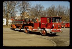 an old fire truck is parked on the street