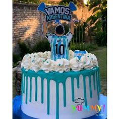 a blue and white cake with a soccer player on top that says vamos arentina