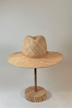 Straw panama hat with a tan leather band. Brown Straw Hat For Travel, Brown Straw Hat Bands For Summer, Brown Brimmed Panama Hat For Spring, Brown Woven Panama Hat For Travel, Brown Toquilla Straw Fedora For Spring, Everyday Natural Fedora With Flat Brim, Spring Brown Toquilla Straw Fedora, Brown Straw Boater Hat For Travel, Summer Hat Bands In Brown Toquilla Straw