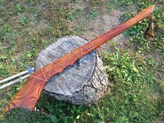 a wooden guitar sitting on top of a tree stump