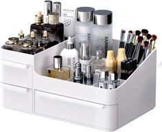 a white container filled with lots of different types of cosmetics and beauty products on top of each other