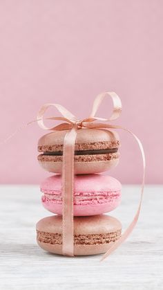 three macaroons wrapped in pink and brown ribbon