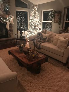 a living room filled with furniture and a christmas tree