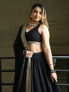 This black georgette lehenga choli set is the epitome of elegance and sophistication. Its detailed embroidery, sequin work, and heavy lace embellishments make it a standout choice for any special occasion.  The ability to customize the choli ensures a perfect fit, while the voluminous lehenga and intricately designed dupatta complete the ensemble, making it a perfect choice for those looking to make a lasting impression.
Complementing the lehenga is a matching choli that maintains the same Black Embellished Sharara For Diwali, Black Sharara For Reception During Navratri, Bollywood Style Embellished Black Sharara, Black Anarkali Style Embellished Pre-draped Saree, Fitted Black Anarkali Pre-draped Saree, Semi-stitched Embellished Black Sharara, Embellished Semi-stitched Black Sharara, Designer Black Embellished Sets, Black Floor-length Sequined Pre-draped Saree