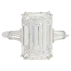 an emerald - cut diamond ring with baguets