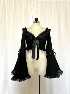 Stop the show and take a look at this beauty. Meet the Roselyn Top. She is a mystery and a blast. Roselyn is a crop top made with a gorgeous gauze stretch cotton, accompanied with a dramatic bell sleeved, Raschel ruffled lace trim, all tied together with a satin bow tie front.  iMPORTANT ♥️ Please contact us if you need or want an order by a certain time frame as our production and shipping times vary. We need to know in advance for orders with specific deadlines. Thank you! Bell Sleeve Bolero, Gothic Tops With Sheer Sleeves For Spring, Elegant Cropped Crop Top With Sheer Sleeves, Fall Crop Top With Sheer Sleeves, Elegant Cropped Tops With Sheer Sleeves, Evening Crop Top With Sheer Sleeves, Witchy Long Sleeve Party Tops, Witchy Long Sleeve Tops For Party, Gothic Cropped Top For Party