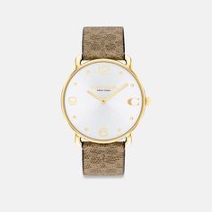 With clean lines and a modern minimalist sensibility the Elliot is a true design classic ready for workdays and weekends. Finished with a Signature canvas strap this gold tone round watch features a sunray dial detailed with our Signature marker at 3 o’clock. | Coach Elliot Watch, 36 Mm - Women's - Tan Coach Watches Women, Coach Watch, Round Watch, Signature Canvas, 3 O Clock, Minerals Crystals, A Signature, O Clock, Quartz Movement