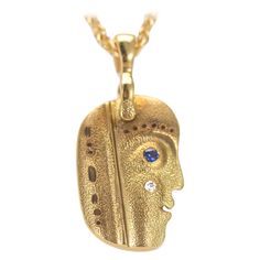 From the studio of Alex Sepkus in New York - 18 karat hand-hammered yellow gold "Till We Have Faces" pendant necklace with 1 brilliant white diamond and 1 blue sapphire. Diamond weight is 0.01 carat and blue sapphire weight is 0.01 carat. Pendant measures 14 millimetres tall and 9.5 millimetres across. Includes a cable link chain with lobster claw clasp. Chain is 18" long. This necklace is of the heirloom quality you love and expect from Alex Sepkus. Made by hand in New York City by highly skill Till We Have Faces, Alex Sepkus, Face Necklace, Blue Sapphire Diamond, Sapphire Diamond, Gold Yellow, White Diamond, Link Chain, Diamond White