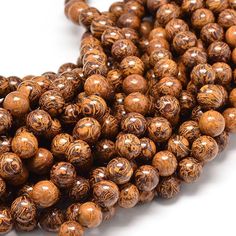 the beads are brown and have intricate designs on them