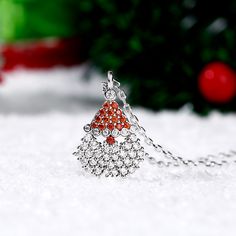 Our Santa Claus necklace is a great way to show your Christmas spirit and even if you don't catch a glimpse of Santa and his reindeer on Christmas eve you'll still have this amazing Christmas necklace to show how thankful you are for all the gifts he brings! The shimmering Santa pendant necklace sparkles with glittering white and red stones and will add some whimsy to your holiday outfit.Carat Weight: 1.989 ctStone Size: 1.1,1.4,1.6,1.6,1.4 mmStone Type: Jeulia® StoneNumber of Stones: 54 Stone S Elegant Christmas Holiday Jewelry, Elegant Christmas Holiday Necklaces, Holiday Sterling Silver Necklace, Holiday Party Silver Necklaces, Sterling Silver Round Necklace For Christmas, Holiday Party Silver Necklace, Silver Christmas Holiday Jewelry, Silver Holiday Jewelry, Silver Jewelry For New Year Gift