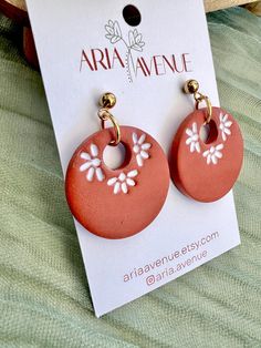 two pairs of earrings with flowers on them