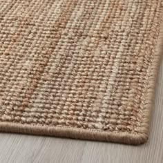 a close up view of a rug on the floor with light brown and beige colors