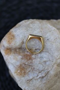 Get a ring upgrade with Rev Ring! This beauty features a gold plated band and a stunning mother of pearl inlay. Available in 3 sizes (6, 7, or 8), it's not just for show - it's stainless steel making it waterproof and life proof. Upgrade your ring game now! Also available in white. Minimalist Open Ring Jewelry With Polished Edges, Classic Brass Jewelry For Promise Ring, Gold Stainless Steel Ring With Polished Finish, Classic Gold Open Enamel Ring, Gold Stainless Steel Minimalist Ring, Modern Black Enamel Ring Jewelry, Gold Minimalist Stainless Steel Ring, Minimalist Gold Stainless Steel Rings, Modern Black Enamel Ring