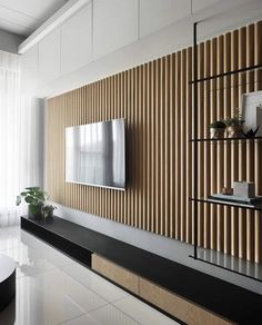 a living room with a large television mounted to the side of it's wall