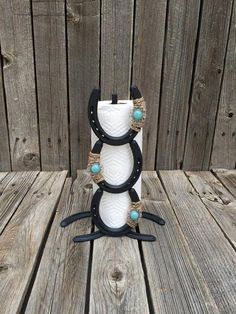 a black and white vase sitting on top of a wooden table next to a fence