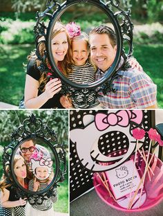 a couple and their daughter posing for pictures in front of a mirror with hello kitty on it