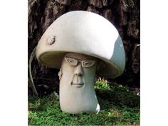 a statue of a man's head under a mushroom