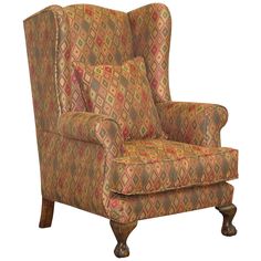 an upholstered wing chair with a colorful pattern on the back and armrests