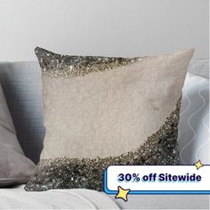 a pillow that is on top of a couch with the words 30 % off sitting next to it