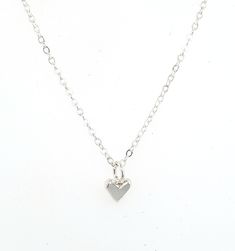 "This is a tiny tiny little heart charm made out of solid sterling silver. It is perfect for layering with other necklaces, or wear it on it's own for a nice and simple necklace. It's perfect for a discrete and minimalist everyday necklace :) The photo on the neck form shows the charm on a 16\" chain, however you can chose between 16\", 18\", or 20\". I make all of my jewelry by hand in my Savannah, GA studio. Please contact me if you have any questions :)" Dainty Everyday Heart Charm Necklace, Minimalist Everyday Charm Necklace With Heart Charm, Minimalist Everyday Necklace With Heart Charm, Dainty Small Heart Necklace For Everyday, Minimalist Everyday Charm Necklace With Heart, Dainty Heart Pendant Charm Necklace For Everyday, Dainty Everyday Heart Pendant Charm Necklace, Minimalist Heart Charm Jewelry For Everyday, Minimalist Nickel-free Heart Pendant Jewelry