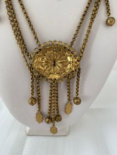 "Etruscan Revival Festoon Necklace and Bracelet Set Gold Tone Ornate Vintage Patina Necklace - 16.5\" plus festoon drop with dangles additional 4\" Length Bracelet - 7.5\" Bracelet medallion 1.76x x 1.50@ No markings Aged patina, can use white vinegar to brighten if preferred" Antique Locket Jewelry For Festive Occasions, Antique Locket For Festive Occasions, Vintage Locket Jewelry For Festivals, Vintage Festival Locket Jewelry, Ornate Filigree Necklaces For Festivals, Gold Vintage Charm Necklace For Festival, Gold Necklace With Vintage Charm For Festival, Gold Bohemian Bridal Necklace For Celebration, Antique Adjustable Necklaces For Ceremonial Occasions