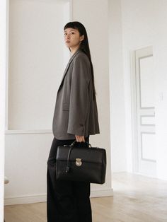 Editor's NotesFELLO's accessory is unique and perfect for everyday wear.- Light-weighted modern briefcase bag- Eye-catching leather texture- Good storage of capacity- Vintage and minimal style- Daily point itemMeasurements(in.)- Size: 14.6in. (W) * 10.2in. (H) * 3.5in. (D)Composition & Care- Cow leather- Avoid direct heat and moisture- Professional cleaning is recommendedDesigner- by FELLO Timeless Structured Shoulder Bag For Business, Modern Rectangular Briefcase For Business Trips, Modern Satchel For Business Trips, Modern Shoulder Bag For Business Trips, Modern Rectangular Laptop Bag For Business Trips, Minimalist Briefcase For Work, Minimalist Business Briefcase, Modern Business Satchel With Rectangular Case, Black Structured Business Bag