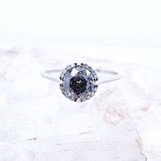 a diamond ring sitting on top of a rock