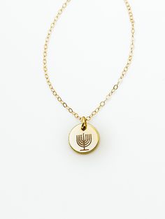 "Made in Portland, Oregon. I'll be honest I was always jealous of all the cute Christmas jewelry out there, so like any good entrepreneur I made my own Hanukkah line! Enjoy, share and have some fun this holiday season!  MEASUREMENTS + MATERIALS - Length comes in 16, 18 or 20 inches and is adjustable another 2 - Charm is about 10mm in diameter - Menorah stamp has 9 candles for Hanukkah  - Gold fill chain for sensitive skin (hypoallergenic) - Rose gold fill and silver fill are also available  WHAT Star Of David Charms Jewelry For Gift, Gold Star Of David Necklace Nickel Free, Gold Nickel-free Star Of David Necklace, Gold Star Of David Jewelry For Hanukkah, Gold Star Of David Charm Necklace For Gift, Gold Star Of David Charm Necklace As Gift, Nickel-free Star Of David Jewelry Gift, Hanukkah Pendant Jewelry, Hanukkah Gift Pendant Jewelry