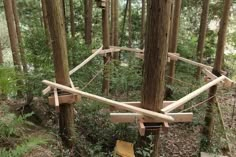 an upside down wooden structure in the woods