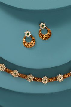 Keep it chic and simple with this antique necklace by Tarinika. Timeless and elegant, the antique-gold tone plated design features a dazzling CZ floral motifs. It is perfect for small events and day occasions, it is a must-have jewelry piece in your box and would make a great gift. Easy to mix and match with other Tarinika antique jewelry collections. Elegant Antique Gold Necklaces For Festive Occasions, Elegant Antique Gold Necklace For Festive Occasions, Elegant Antique Gold Kundan Necklace Gift, Elegant Antique Gold Kundan Necklace With Intricate Design, Ornate Gold Necklace For Reception, Elegant Antique Gold Kundan Necklace, Elegant Kundan Necklace In Antique Gold, Antique Gold Jeweled Jewelry For Weddings, Elegant Gold Kundan Necklace Made Of Brass