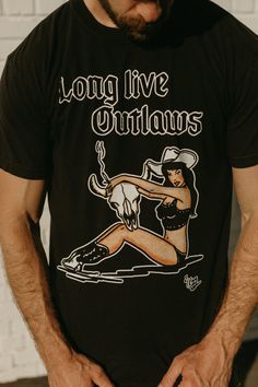 El Ray Long Live Outlaws art is licensed Comfort Colors T-shirt is true to size. Size up for more oversized fit Unisex Band Merch Cotton T-shirt With Custom Artwork, Cotton Band Merch T-shirt With Custom Artwork, Cotton Tops With Custom Band Artwork, Cotton Tops With Custom Artwork For Streetwear, Relaxed Fit T-shirt With Front Print For Concert, Band Merch Tops With Custom Artwork, Fan Merchandise Graphic Tee With Back Print, Graphic Tee Tops With Custom Artwork For Fans, Graphic Tee With Back Print For Fan Merchandise