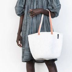 "White sisal tote bag DIMENSIONS Bottom width: 10\"/25.5cm Top width: 14\"/35.56cm Depth: 10\"/25.5cm Straps: 15\"/38cm SHIPPING All orders ship via DHL Express (3-5) days delivery time." Eco-friendly White Bag In Natural Fiber, Eco-friendly White Bag With Natural Fiber, White Natural Fiber Tote Bag, White Tote Bag In Natural Fiber, White Natural Fiber Tote Beach Bag, White Natural Fiber Bag With Braided Handles, White Bag With Braided Handles In Natural Fiber, White Natural Fiber Bags With Braided Handles, White Bags With Braided Handles In Natural Fiber