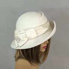 This beautiful ladies hat is made from lush fur felt, and hand draped over an antique hat block. Hand finished with authentic millinery techniques. Has millinery wire to maintain its shape. Embellished with Dupioni Silk. This is the perfect flattering hat...asymmetrical, diagonal front draping, with my signature pleating in the crown. Please indicate your head size measurement when ordering (measure your head horizontally just above your eyebrows). When you receive your hat, there will be a smal Kentucky Derby Fur Felt Cloche Hat With Flat Brim, Cream Short Brim Felt Hat For Kentucky Derby, Fur Felt Boater Hat For Kentucky Derby, Elegant Cream Felt Hat For Winter, Kentucky Derby Fur Felt Cloche Hat With Short Brim, Fur Felt Cloche Hat For Kentucky Derby, Elegant Beige Fur Felt Fedora, Elegant Beige Wool Felt Hat, Formal Wide Brim Fur Felt Cloche Hat