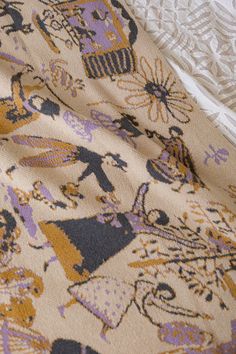 a close up view of a blanket with an animal pattern on it and white lace