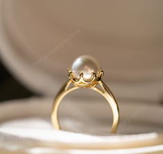 An elegant and glamour open-style ring with a lustrously freshwater pearl. This simple ring makes a sophisticated statement by the unique design. A must have in your jewelry collection, it will look fantastic paired with any of your outfits. We made this  pearl ring for classy women. You can wear it everyday and everywhere. Our  Signature Pearl ring is designed to be comfortable and easy to wear. Item Details Metal: 925 Sterling Silver Main stone creation- Pearl Main Stone Color: White Main Ston Wedding Pearl Open Ring, Open Pearl Ring For Wedding, Pearl Open Ring For Wedding, Handmade Open Pearl Ring For Wedding, Wedding Pearl Open Ring Jewelry, Wedding Pearl Jewelry With Open Ring Design, Wedding Pearl Jewelry With Open Ring Shape, Luxury Handmade Pearl Ring For Wedding, Elegant Handmade Gold Pearl Ring