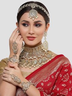 This jewelry set consists of a necklace, a pair of earrings, 2 hathphool bracelets and matha pattiGold-plated necklace has white kundan-studded and white pearls beaded detailsSecured with a drawstring closureA pair of matching drop earrings, each secured with a post-and-back closure2 matching hathphool bracelets, secured with a s-hook closureA matching Matha patti, secured with a hook closure Size & Fit Size of the necklace: 24 cm x 12 cm (Length x Width)Size of the earrings: 11 cm x 5.5 cm(Length x Width)Size of the Mathapatti: 11 cm x 23.5 cm(Length x Width)Size of the Hathphool: 13 cm x 16 cm (Length x Width) Material & Care Material: AlloyPlating: Gold-platedStone Type: Kundan and Beads Care InstructionsWipe your jewellery with a soft cloth after every useAlways store your jewellery in Matha Patti Bridal, Beaded Bridal Jewelry, Bridal Jewellery Set, Matha Patti, Anarkali Lehenga, Wedding Jumpsuit, Gold Fashion Necklace, S Hook, Jewellery Set