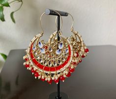 Red Meenakari Kundan Hoop Chandbali Earrings. Stylish Fancy Party Wear Jhumka Earrings . Height: 3 inch Width: 2.5 inch These Jhumka Ear Rings can be worn with all kind of traditional Outfits.These beautiful Earrings are handcrafted in brass alloy with pearl stones of very fine quality. Ideal Gift for Wife, Girls, Women, Girlfriend.Ethnic Wear. Can be worn for engagement and wedding parties. Handcrafted pair of earrings. Gives traditional look. Indulge in it or gift it and watch the compliments Pakistani Earrings, Pink Pearl Earrings, Chandbali Earrings, Fancy Party, Indian Earrings, Jhumka Earrings, Pink Pearl, Gifts For Wife, Party Wear